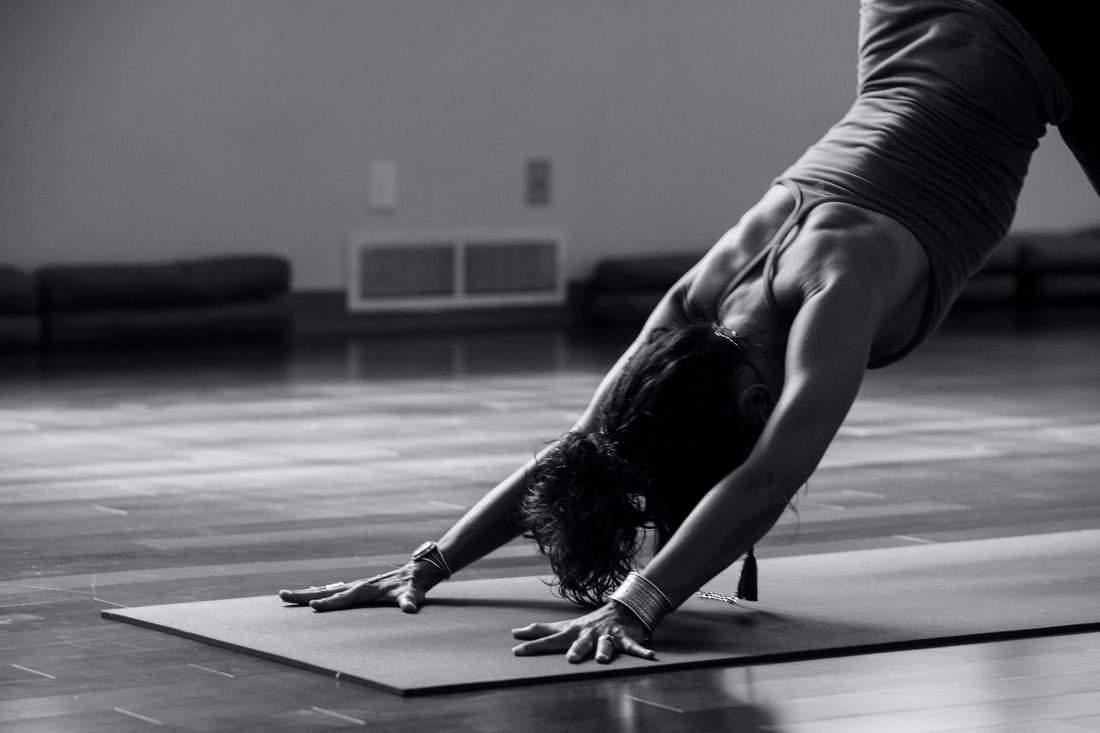 Woman making yoga bikram triangle pose on mat Stock Photo by  ©Syda_Productions 144884527